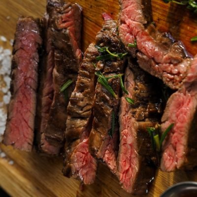 High-protein animal-based foods including steak, and butter on a cutting board